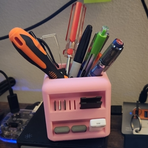 a pink desk organizers filled with pens, tools, and usb devices