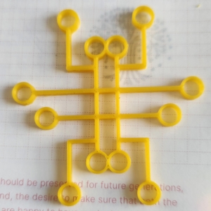 the finished yellow plastic logo on a journal page